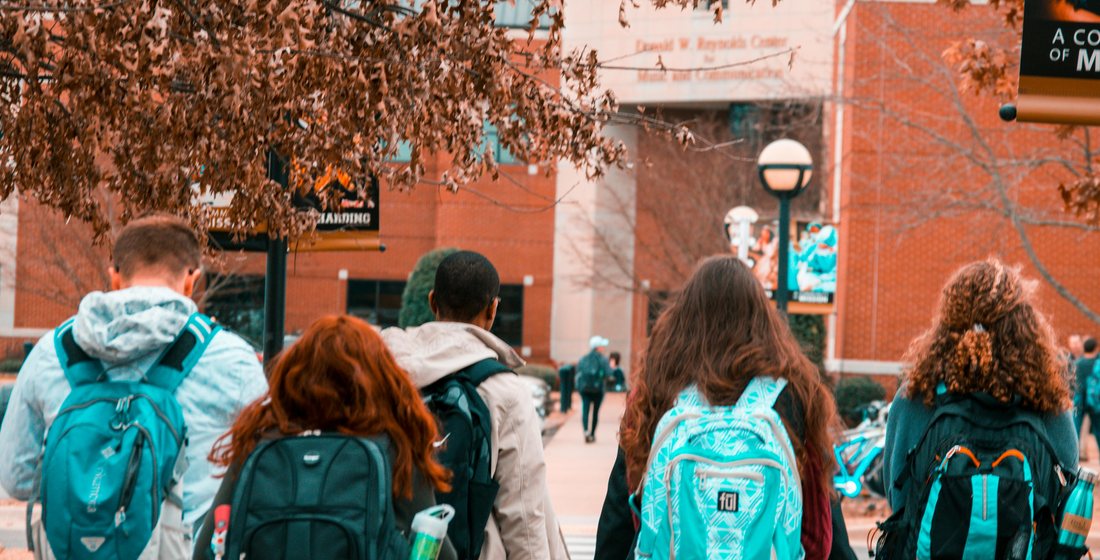 Students walking towards a university campus after choosing their pre-university pathway
