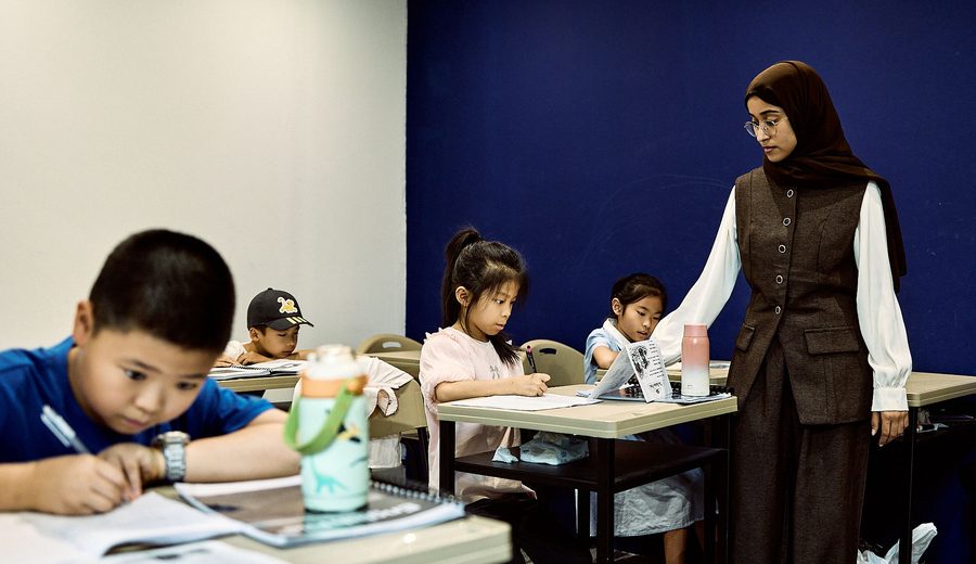 Small group of students practising spoken English together in class